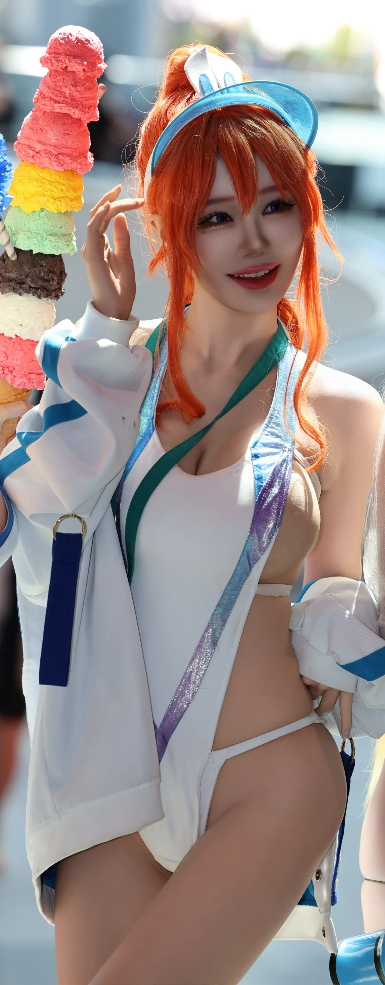 A cosplayer with orange hair and a blue and white costume