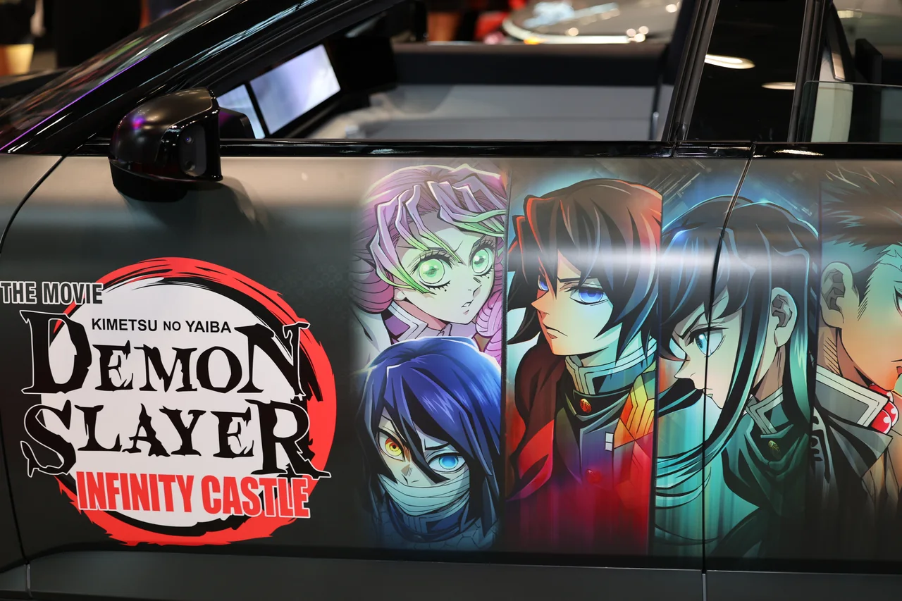 Anime character artwork on the door of a car at a convention