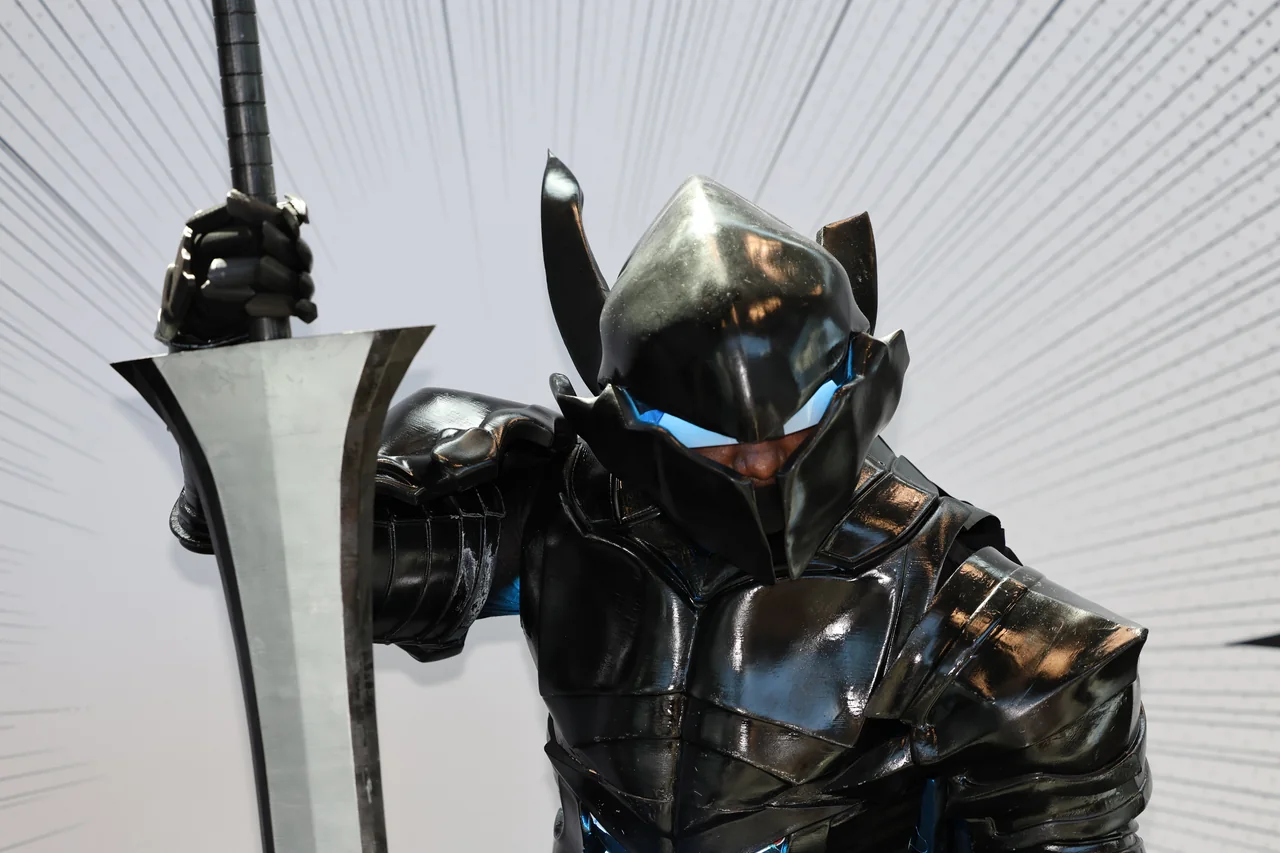 Low-angle portrait of an armored cosplayer holding a large sword