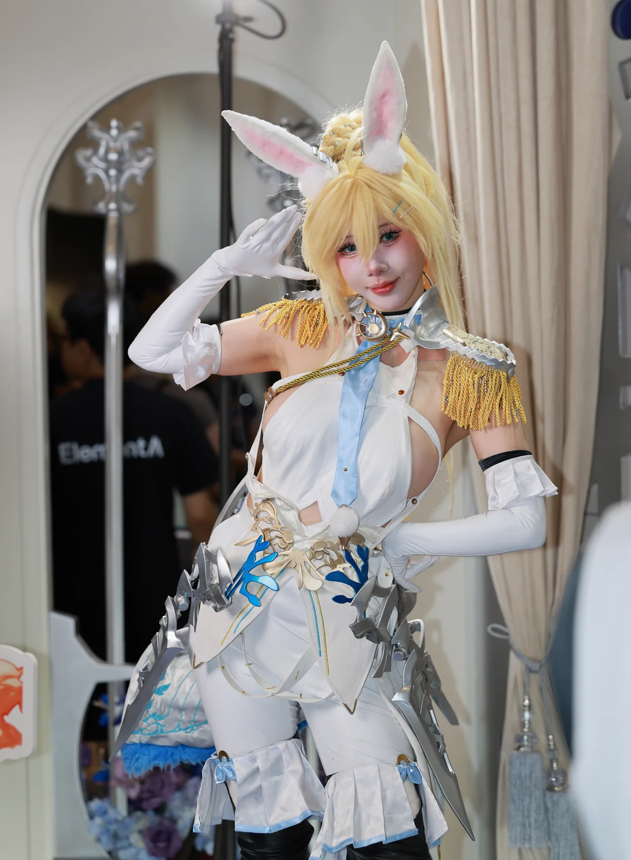 Full-length portrait of a cosplayer in white and gold with tall rabbit ears